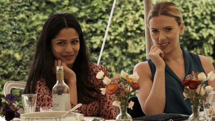 My Mother's Wedding: Freida Pinto and Scarlett Johansson sit together at a table at a wedding reception
