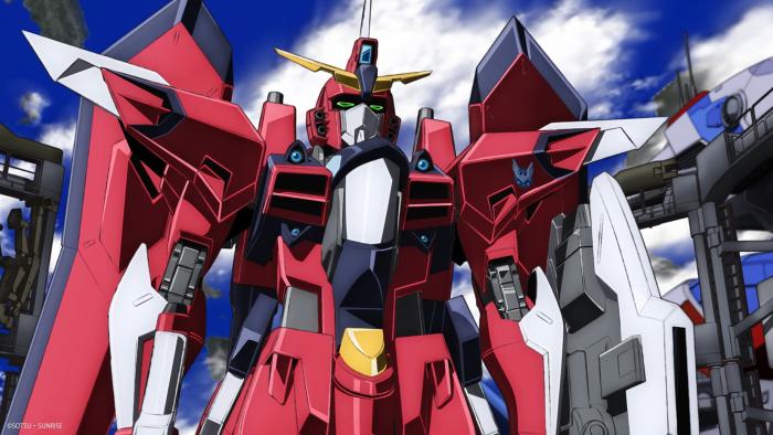 Mobile Suit Gundam SEED FREEDOM movie: Large red robot mech stands at the ready under a blue sky with clouds