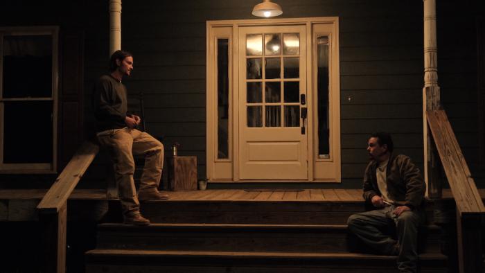 Mob Land Movie: Shelby Conners (Shiloh Fernandez, left) stands on his front porch at night, talking with brother-in-law Trey (Kevin Dillon, right)