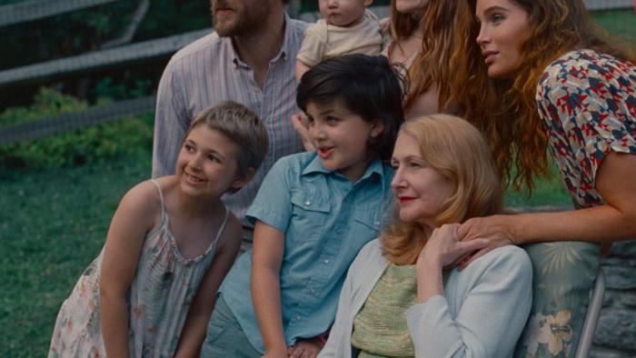 Monica Movie: White family posing for a photo on a lawn