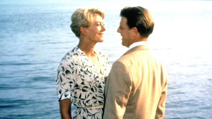 A Month by the Lake: Vanessa Redgrave and Edward Fox stand facing each other, smiling, Lake Como in the background