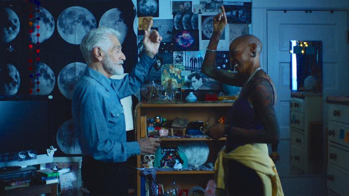 Moon Manor Movie: Jimmy (James Carrozo, left) and his death doula, Fritti (Debra Wilson, right), discuss the signal that Jimmy will give to let her know that it's time