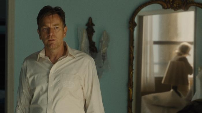 Mother, Couch Movie: David (Ewan McGregor) looks uneasy as he watches his mother, who's reflected in a nearby mirror