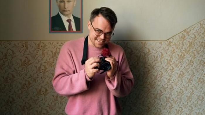 Mr. Nobody Against Putin: Teacher Pasha Talankin smiles at the camera while holding his own camera