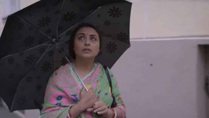 Mrs. Chatterjee vs. Norway: An Indian mother walks with umbrella wearing pink and green sari