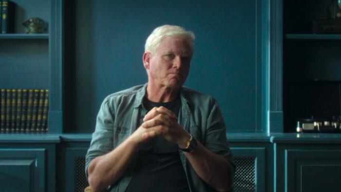 Murder in Monaco film: Ted Maher clasps his hands together as he sits in an interview chair