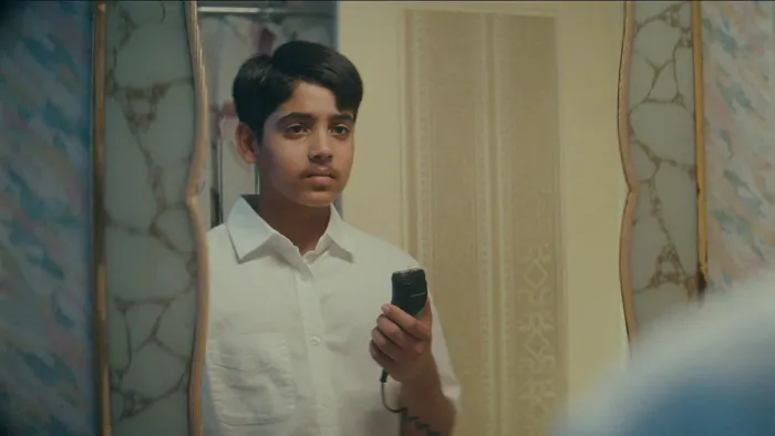 Mustache: Boy looks in mirror.