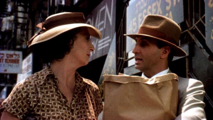 Enemies, a Love Story: Ron Silver holding groceries while talking to Anjelica Huston