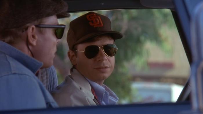 My Blue Heaven: Rick Moranis sits in car on stakeout