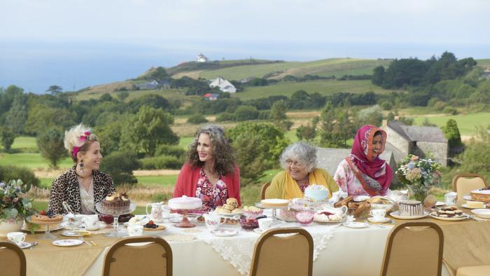 My Happy Ending Movie: Four women sit at a dining table outdoors on a hill