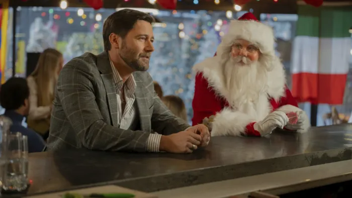 My Secret Santa: Alexandra Breckenridge as Santa shares a drink with Ryan Eggold. 