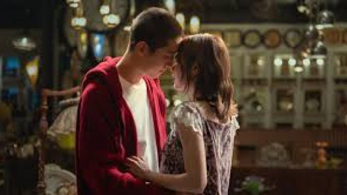 My Dearest Assassin: Young couple sharing a tender moment in a warmly lit room.