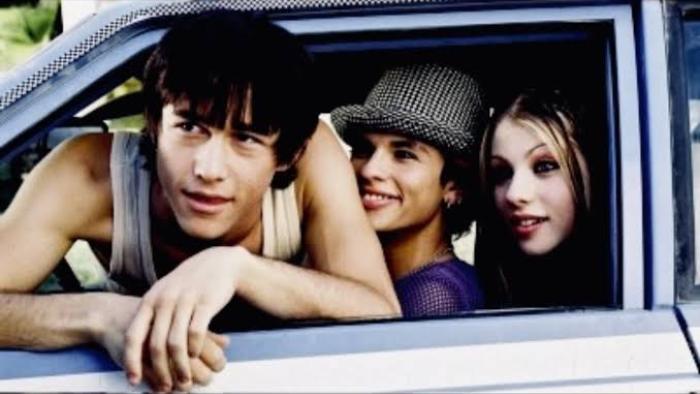 Mysterious Skin Movie: Three people smiling from a car window, one wearing a hat.