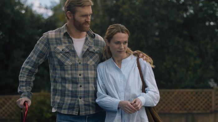 Night Swim Movie: Ray Waller, leaning on a red cane, wraps his arm around his wife, Eve, looking confident and hopeful