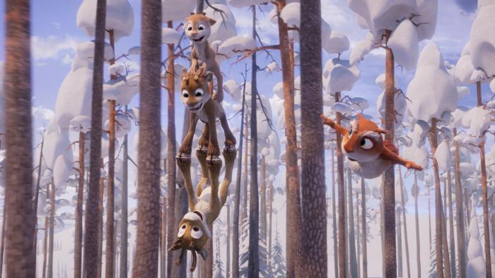 Niko — Beyond the Northern Lights: Three young reindeer stack on top of each other as they play in the weeds, a squirrel flying alongside them