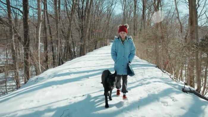 Not My Dog movie: Rylie Pennington walks next to Nudge the dog in the snow