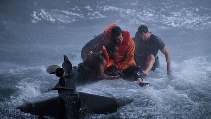 Not Without Hope movie: Zachary Levi holds onto Quentin Plair as he sits on top of a capsized boat