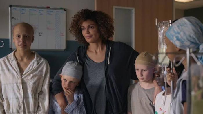 Nothing to Lose movie: Diverse group in hospital, some wearing caps, standing together.