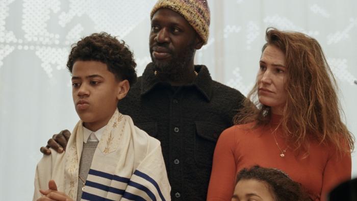 Occupied City Movie: An interracial Jewish family of four stands together