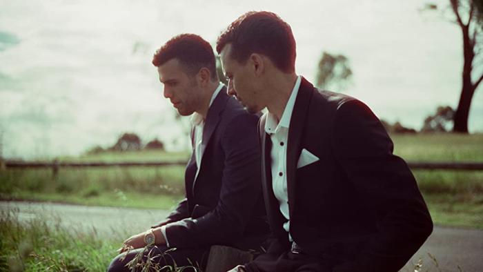 Of an Age Movie: Thom Green and Elias Anton sit together outside 