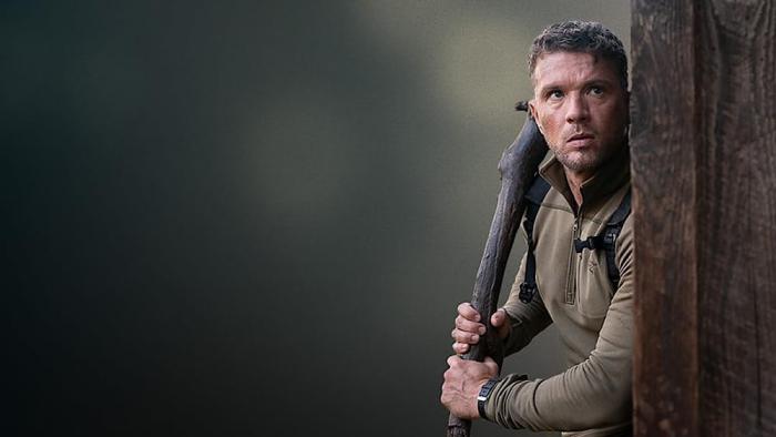 One Mile: Chapter Two movie: Ryan Phillippe stands holding a pipe around the corner of a building