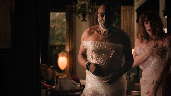 One Night Only movie: Rick (Levar Burton) and Linda (Molly Ringwald)) look surprised to be interrupted while covered in bubble wrap