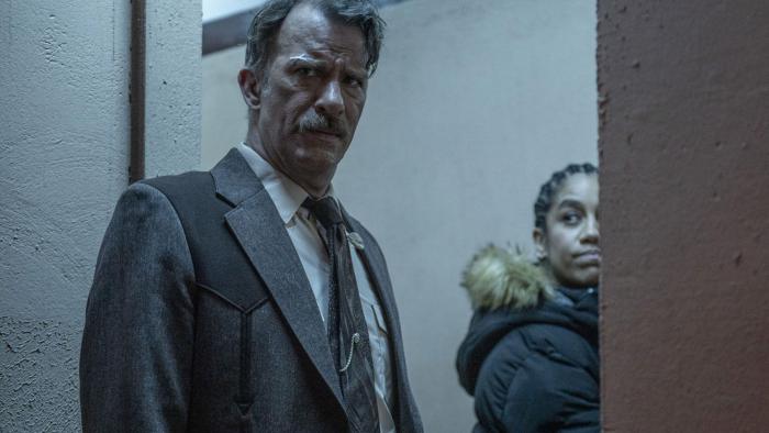 One Ranger Movie: Texas Ranger Alex Tyree (Thomas Jane) and British Intelligence Agent Jennifer Smith (Dominique Tipper) cautiously peer around a doorway