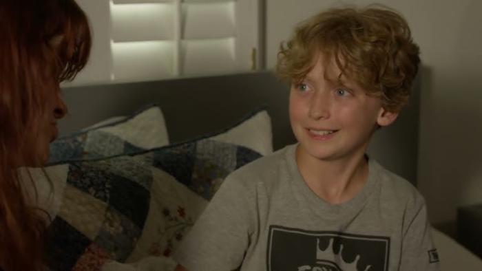 Operation Friendship: a young boy smiles at a character offscreen 