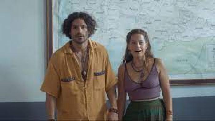 Oregon movie scene 2: A  man and woman stand in front of a map