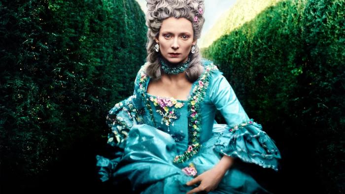 Orlando: Tilda Swinton runs through an ornate garden wearing a formal blue dress