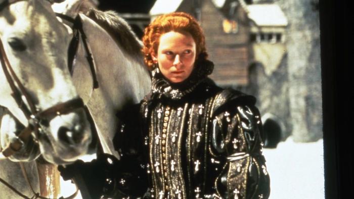 Orlando: Tilda Swinton stands in elaborate Elizabethan clothing next to a white horse