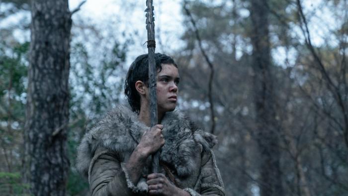 Out of Darkness Movie: Beyah (Safia Oakley-Green) stands in the woods, at the ready, holding her spear and draped in furs