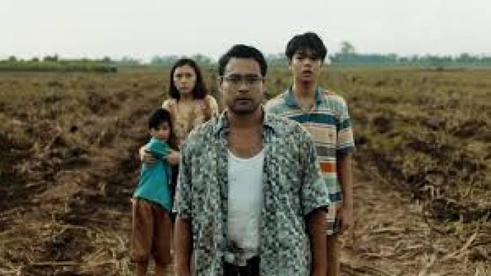 Outside:  Man with woman and 2 boys in background