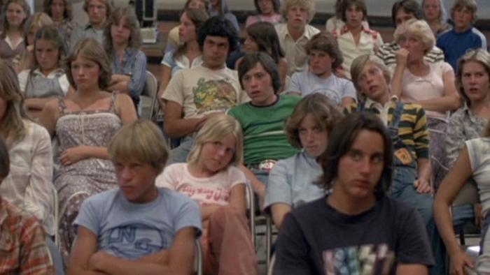 Over the Edge: A roomful of kids sitting on folding chairs look bored