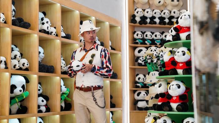 Panda Plan Movie: David (Wei Xiang) checks out the panda merchandise in the zoo gift shop