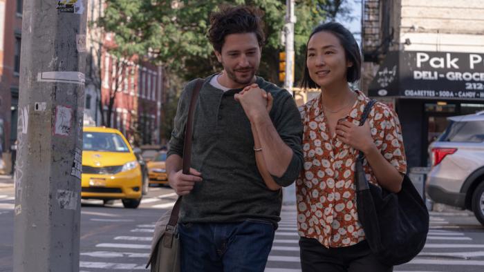 Past Lives: a White man holds hands with an Asian woman 