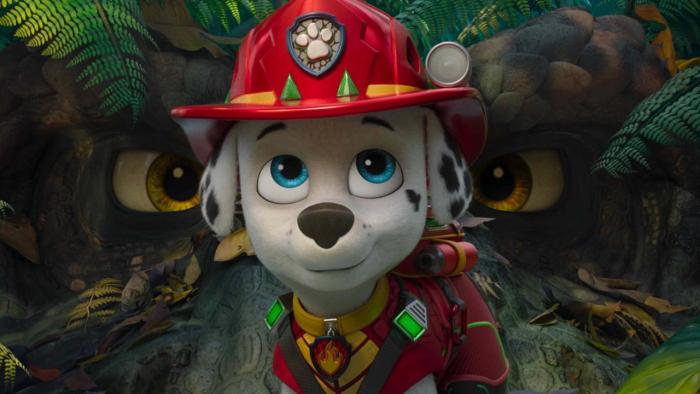 Paw Patrol: The Dino Movie: Marshall poses in front of a dinosaur