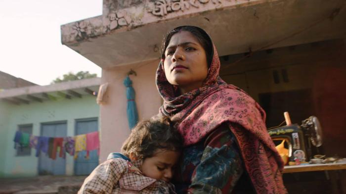 Period. End of Sentence Movie: A woman holding a young child