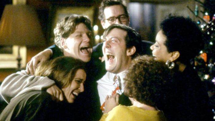 Peter's Friends: A group of adults embrace in a circle, laughing