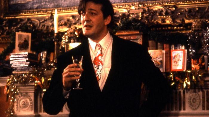 Peter's Friends: Stephen Fry holds a glass as he stands in front of a fireplace