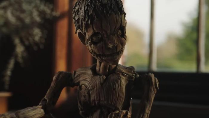 Pinocchio Unstrung Movie: The wooden Pinocchio puppet looks like he's listening to someone speak