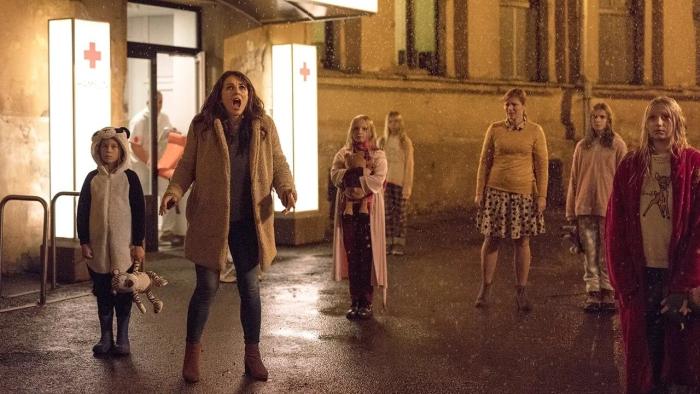 Piper: Elizabeth Hurley stands outside a large building, looking shocked, with children standing around her