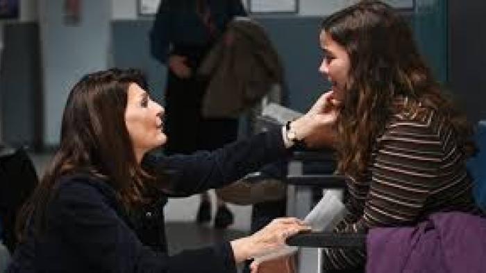 Poisoned Love: The Stacey Castor Story: Nia Vardalos comforts a seated girl in a waiting area.