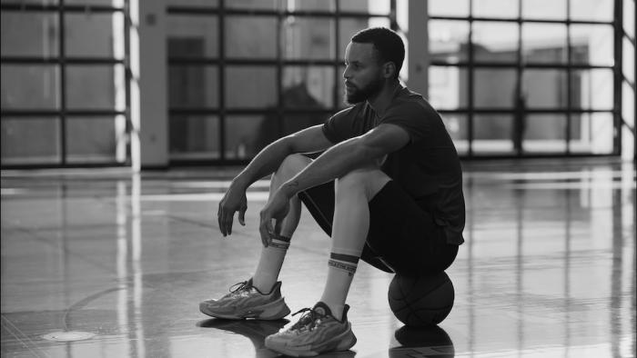 Portrait of an Artist: Stephen Curry Movie: In a black-and-white image, Curry sits on a ball as if contemplating something