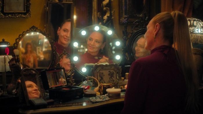 Pretty Lethal: Uma Thurman sits in front of a lit dressing room mirror doing her makeup