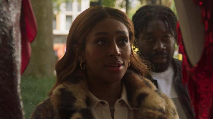 Pretty Red Dress: Alexandra Burke looks into a shop window with Natey Jones standing behind her, both looking at a red dress on display