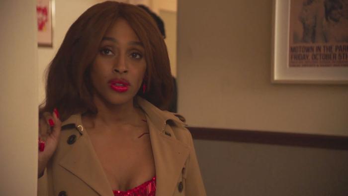 Pretty Red Dress: Alexandra Burke looks unsure as she stands in a doorway, her hair and make-up done