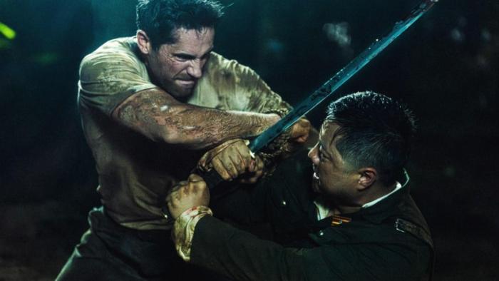 Prisoner of War: A White man and a Japanese soldier with a sword fight in the rain