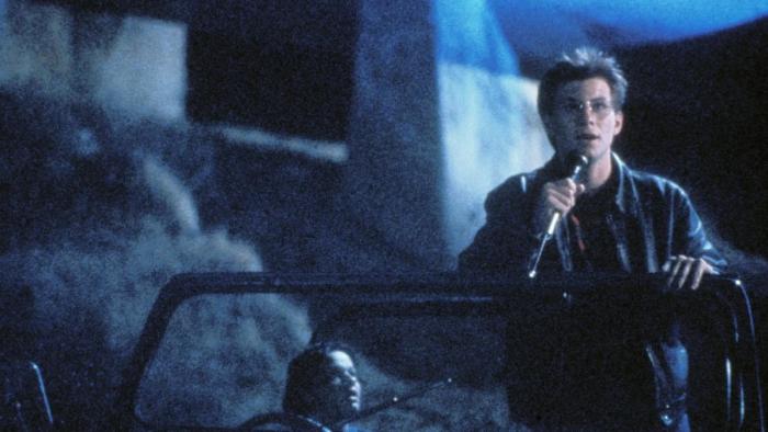Pump Up the Volume: Christian Slater speaks into a microphone as he stands in an open-top car driven by Samantha Mathis