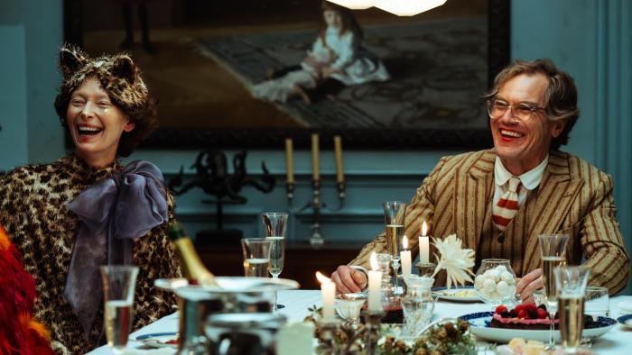 The End: Tilda Swinton and Michael Shannon dressed up at a dinner party laughing